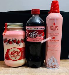 three different types of drink sitting on a table next to each other with the same bottle in front of them