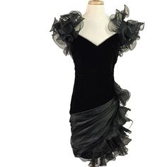 Exaggerated Black Organdy Ruffle Shoulders and ruffles from hip to hem, with sashed satin on a soft velvet ruched sheath. Measurements Flatlay Seam-Seam w/o Stretch Length: 36 in / 91 cm Width: 16.5 in / 42 cm Waist: 15 in / 38 cm Hip: 19 in / 48 cm ** This vintage party dress is a showstopper both coming and going. It's in very good condition. It had obviously been packed away. I spend some time steaming and puffing up the ruffles. More of this is necessary to bring the dress to full bloom.  The rhinestone V Neck -appears to be completely intact. Size: Womens M Features: * Weight: 15 oz This item is listed on multiple selling platforms We ship worldwide Evening Velvet Dress With Ruffles, Vintage Party Dress, Velvet Party Dress, Vintage Party Dresses, Vintage Party, Soft Velvet, Dress Clothes For Women, Black Velvet, Ruffles