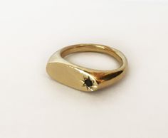 a gold ring with a black diamond on it