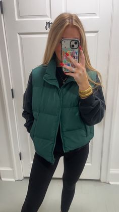 The perfect fall and winter staple!! This is the cutest hunter green puffer vest, it is full length and has pockets. This vest is just perfection and is calling your name. This can be styled with comfy clothes or sweaters. The great thing about puffer vest just elevates an OOTD!!! This comes in Black as well! Outfits With Green Vest, Puffy Green Vest Outfit, Modest School Fits, Green Puffer Vest Outfit Aesthetic, Green Puffer Vest Outfit, Teal Puffer Vest Outfit, Trendy Fall Puffer Vest, Green Puffer Vest