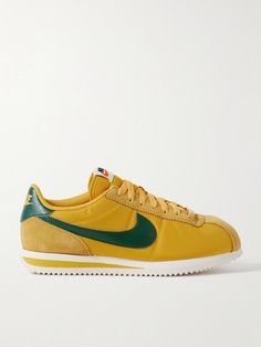 In the 50 years since their debut, Nike's 'Cortez' sneakers have seen numerous iterations, but the silhouette has remained unchanged - a testament to the original design. This version is made from panels of shell trimmed with suede and leather and has a classic 'Swoosh' and cream accent on the serrated sole. The comfortable EVA foam midsole will have you feeling like you're walking on air. Nike Vintage Leather Custom Sneakers, Vintage Nike Low-top Custom Sneakers, Vintage Nike Leather Custom Sneakers, Retro Nike Custom Sneakers With Contrast Sole, Nike Retro Leather Sneakers, Retro Nike Leather Sneakers, Retro Nike Sneakers With Rubber Sole, Retro Sneakers With Contrast Sole, Nike Leather Sneakers With Embroidered Logo