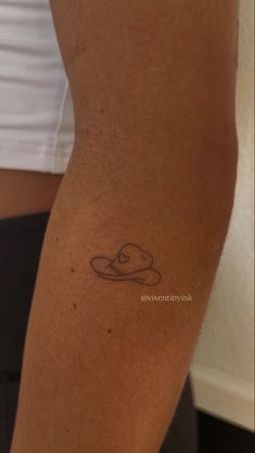 a woman's arm with a tattoo on it and the bottom half of her leg