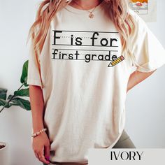 Introducing our charming and funny t-shirt designed exclusively for first-grade teachers--the "F is for First Grade" tee. Celebrate the joy of teaching young minds and showcase your passion for early education with this delightful and stylish garment. Crafted from premium quality, soft cotton fabric, this t-shirt offers both comfort and durability, ensuring that it will be a favorite wardrobe staple for years to come. It's an ideal conversation starter, allowing you to share your enthusiasm for Cotton T-shirt With Name Print For Teaching, Funny Cotton Tops For Back To School, Funny Cotton T-shirt For Teaching, Cotton Tops With Funny Text For Back To School, Back To School Cotton Tops With Funny Text, Cotton Top With Funny Text For Back To School, Fifth Grade Teacher, Third Grade Teacher Shirts, 5th Grade Teacher