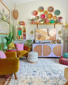 a living room filled with lots of colorful furniture and decor on top of a rug