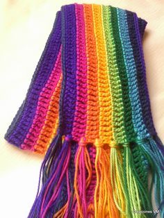 a multicolored crocheted scarf with tassels