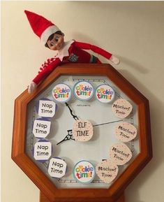 an elf is sitting on top of a clock with magnets attached to the face