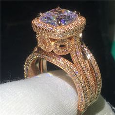 a close up of a diamond ring on top of a white napkin in front of a black background