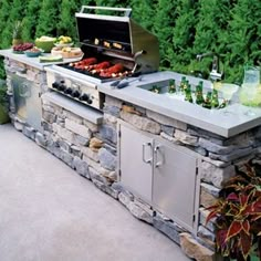 an outdoor grill with food and drinks on it