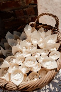 a wicker basket filled with lots of small white flowers on top of a table