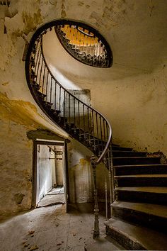 a spiral staircase in an abandoned building