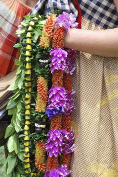 a woman holding a bunch of flowers in her hands