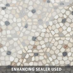 the words enhance sealer used on a mosaic tile floor with white and gray stones