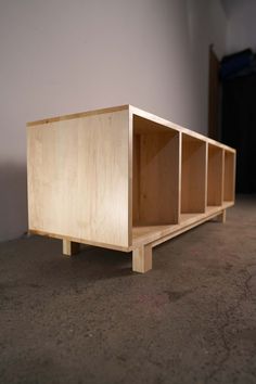 a wooden shelf sitting on top of a floor