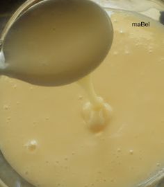 a spoon is pouring batter into a bowl