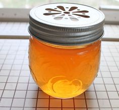 a jar filled with honey sitting on top of a counter