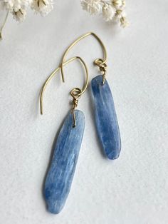 "Silvery, blue beads of natural Kyanite dangle from brass earwires. There are specks of dark blue throughout this beautiful stone. These simple, modern earrings are elegant and lightweight  Earrings are approximately 2 1/4\" in length and come in an organza bag, ready to be gifted or stored! *Blue Kyanite encourages communication and self-expression and is associated with the throat chakra. Kyanite has a calming effect on the whole being, bringing tranquility. ----------------------------------- Pebble Jewelry, Jewelry Minimal, Kyanite Earrings, Architectural Jewelry, Gemstone Earrings Dangle, Silvery Blue, Raw Stone Jewelry, Porcelain Earrings, Mixed Metal Earrings