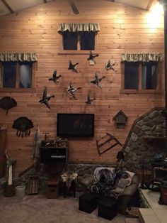 a living room filled with furniture and lots of birds on the wall