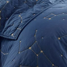 a blue comforter with gold stars on it