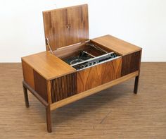 an old record player sitting on top of a wooden cabinet