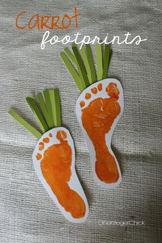 carrot footprints made out of paper on top of a cloth covered surface with the words carrot footprints painted on it