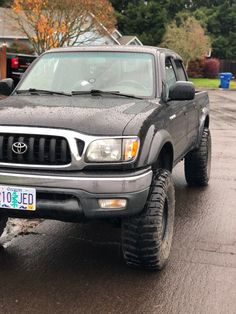 a gray truck parked in front of a house