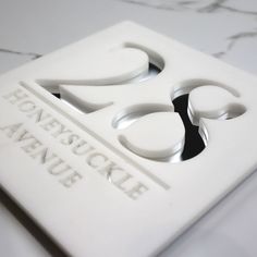 a close up of the logo on a white tile