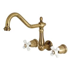 an antique brass faucet with three white flowers on the side and two handles