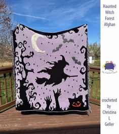 this is an image of a halloween quilt on a deck with the moon and bats