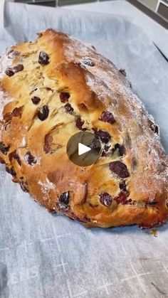 a loaf of bread with raisins on it sitting on top of a table