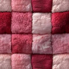 a pink and red blanket with squares on it