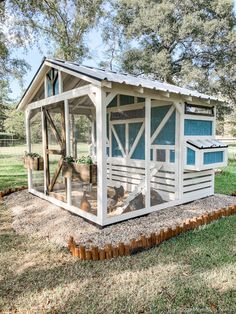 a chicken coop in the middle of a field