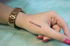 a woman's hand with a tattoo that reads, tutto passe on it