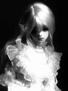 a black and white photo of a doll