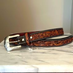 Dark Brown, Hand Tooled With Hide Inlay Leather Belt From Teskeys. Size 28” Longest Hole Measures At 29.50” And Shortest Hole Measures At 25.75”. See The Above Pictures Tooled Leather Womens Belt, Tooled Leather Belts Jacket, Tooled Leather Belts Cheetah, Hand Tooled Leather Necklace, Tooled Leather Belts Cactus, Womens Tooled Western Belts, Custom Hand Tooled Leather Belts, Cowgirl Belts, Bling Belts