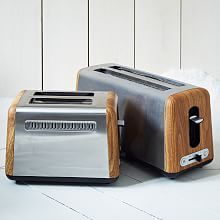 two toasters sitting next to each other on the floor