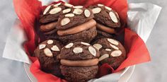 chocolate cookies with almonds in a red paper wrapper