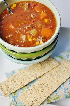 a bowl of soup and crackers on a table