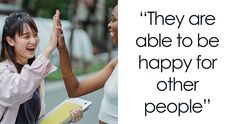 two women giving each other high fives on the street with a quote above them