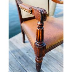 a close up of a chair on a wooden dock