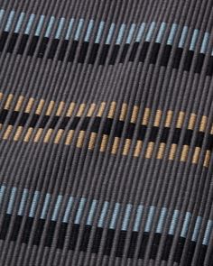 a close up view of a tie with blue and yellow stripes on it's side