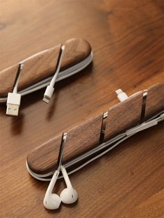 two earbuds sitting on top of a wooden table