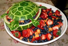 a bowl filled with fruit and a watermelon turtle