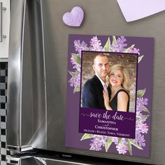 save the date magnets with purple flowers and hearts on them in front of a refrigerator