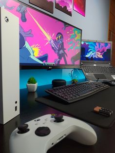 a desk with a keyboard, mouse and two monitors on it next to each other