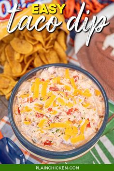 an easy taco dip recipe in a bowl with tortilla chips on the side