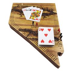 four playing cards are placed on top of a peg board with holes in the middle