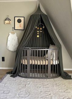 a baby crib in the corner of a room with a canopy over it's bed