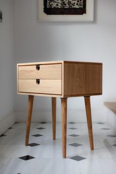 a wooden table sitting on top of a white tiled floor