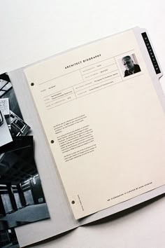 an open book with black and white photos on it's cover, sitting on top of a table