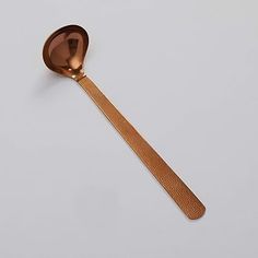 a spoon with a wooden handle on a white surface